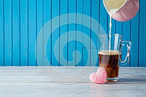 Mother`s day concept with coffee cup and heart shape on wooden table