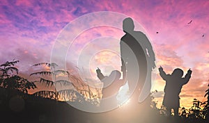 Mother`s Day concept: mom and child on sunset background