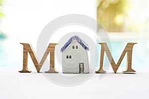 Mother`s day concept, Wooden M text with vintage style ceramic house