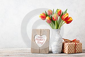 Mother`s Day greeting card with fresh tulips and gift box