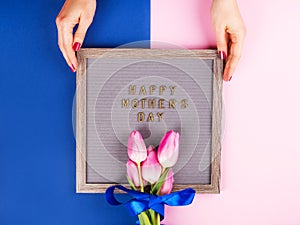 Mother`s day greetings on letter board and tulips