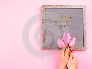Mother`s day greetings on letter board and tulips