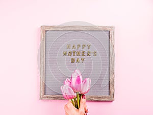 Mother`s day greetings on letter board and tulips