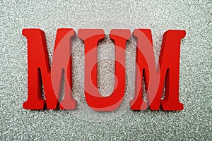 Mother`s day with mum alphabet letter on red glitter background