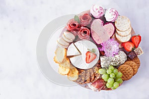 Mothers Day theme charcuterie board against a white marble background photo