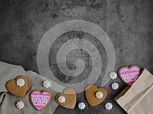 Mother`s Day, Valentines`s Day, Women`s day.Banner of gingerbread hearts on a dark stone background with space for text.Poster f