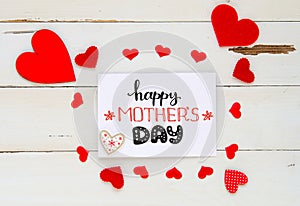 Mother`s Day vintage overhead composition of hearts and hand drawn greeting