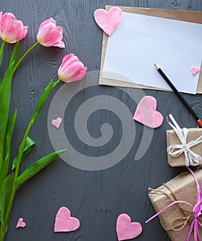 Mother`s Day, woman`s day. tulips ,presents and letter on wooden background