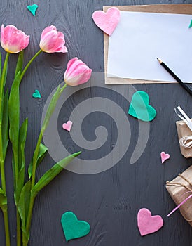 Mother`s Day, woman`s day. tulips ,presents and letter on wooden background