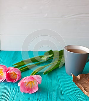 Mother`s Day, woman`s day. tulips ,presents ,tea and sweets on wooden background