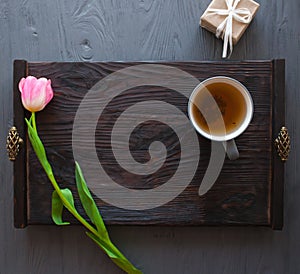Mother`s Day, woman`s day. tulips ,presents ,tea and sweets on wooden background