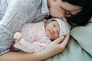 A mother`s daytime sleep with her newborn baby