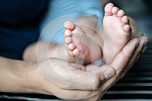 The mother`s hand graced the feet of the newborn photo