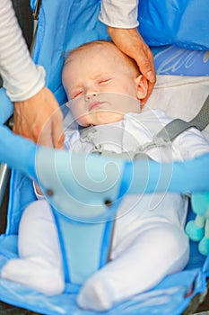 Mother's hand stroking head sleeping baby girl