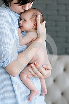 Mother`s love tenderness kiss newborn baby