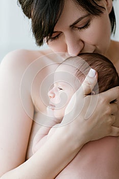 Mother`s love tenderness kiss newborn baby