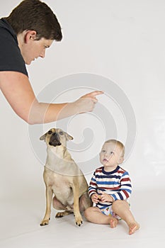A mother scolds her son and his dog photo