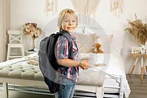 Mother, sending her firstgrader boy to school, first day at school, giving him books and a box with snack