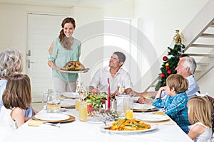 Mother serving Christmas meal to family