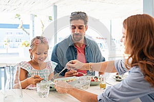 Mother serving daughter lunch