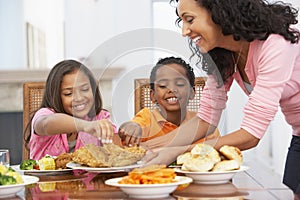 Mother Serving A Meal To Her Children