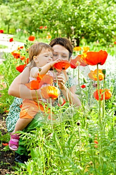 Mother showing flowers to daughter