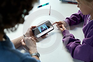 Mother showing video on smartphone to her child