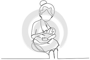 A mother sits breastfeeding her baby