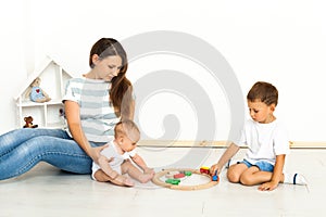 Mother Sitting With kids playing game Indoors