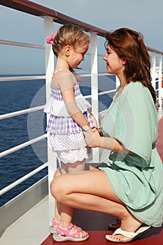 Mother sitting near daughter on cruise liner