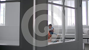 Mother sitting with son reading story indoors.