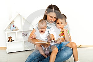 Mother Sitting With Son Reading Story Indoors