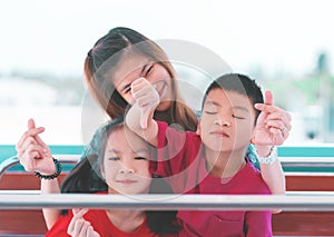 Mother sitting together with her children with everyone smile and one unhappy problem boy