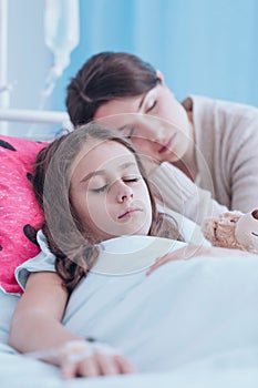 Mother sleeping with sick daughter