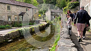 Mother and son admiring the view of Castleton Village with the river running through