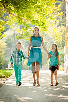 Mother with son adn daughter on a walk in park