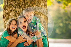 Mother with son adn daughter on a walk in park