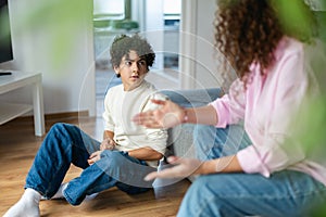 Mother and son arguing with each other at home