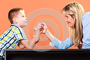 Mother and son arm wrestling.