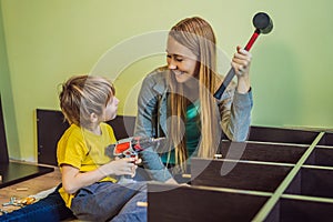 Mother and son assembling furniture. Boy helping his mom at home. Happy Family concept