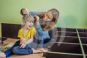 Mother and son assembling furniture. Boy helping his mom at home. Happy Family concept