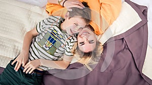 Mother with son on bed, mother and son having fun