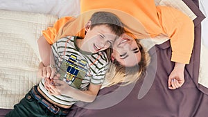 Mother with son on bed, mother and son having fun