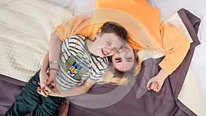 Mother with son on bed, mother and son having fun