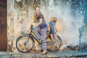 Mother and son on a bicycle. Public street bicycle in Georgetown, Penang, Malaysia