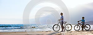 Mother and son biking at beach