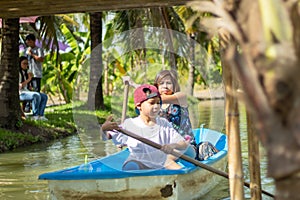 Mother and son boating on the park.