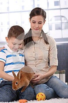 Mother and son with bunny pet