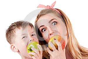Mother son cheerfully biting apple