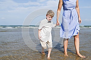 Mother and son chilling at the beach